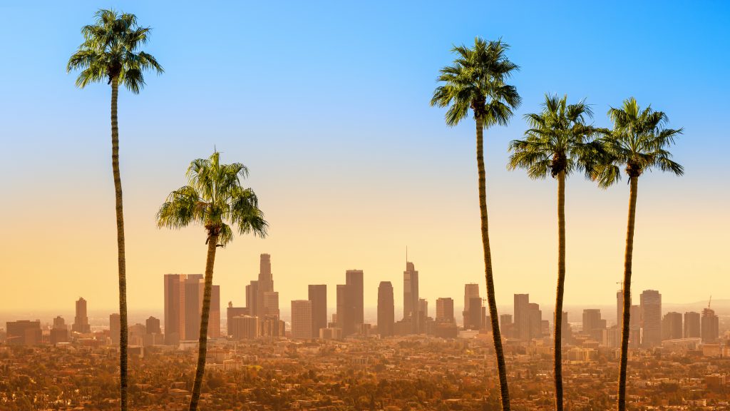 Featured: California city skyline with palm trees in foreground- California Real Estate Still Dictated by Supply and Demand